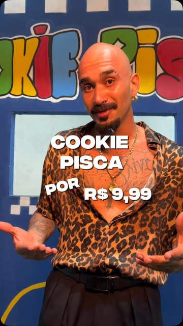Divulgador apresentando o Cookie Pisca por R$ 9,99 diante do letreiro colorido da loja